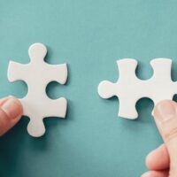 bigstock-Hands-With-Jigsaw-Puzzle-Piece-348576142.jpg