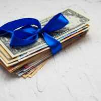 bigstock-Money-Gift-Box-And-A-Lot-Of-Mo-303237775.jpg