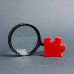 bigstock-Red-Puzzle-And-Magnifying-Glas-299196673.jpg