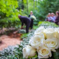 bigstock-Roses-In-Cemetery-With-People-277235128.jpg
