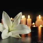 bigstock-White-Lily-And-Blurred-Burning-259838629.jpg